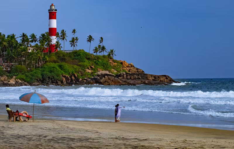 Kovalam Beach Kerala with golden sandy shoreline, lighthouse view and luxury seaside holiday experience by the Arabian Sea